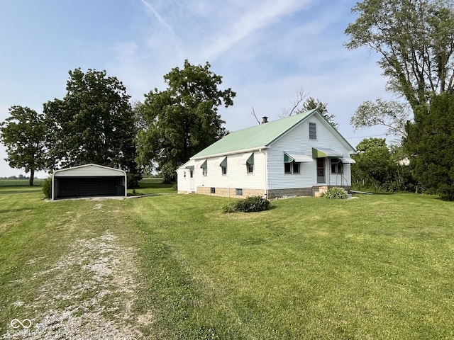 10152 E County Rd 275 N, Seymour, IN 47274 - view of property exterior with a detached carport, a yard, and metal roof