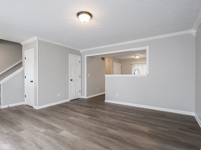 3734 Lacebark Dr, Indianapolis, IN 46235 - empty room featuring wood finished floors, a textured ceiling, baseboards, crown molding, and stairway