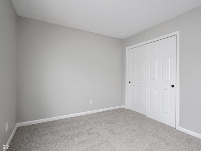3734 Lacebark Dr, Indianapolis, IN 46235 - unfurnished bedroom featuring carpet flooring, baseboards, and a closet