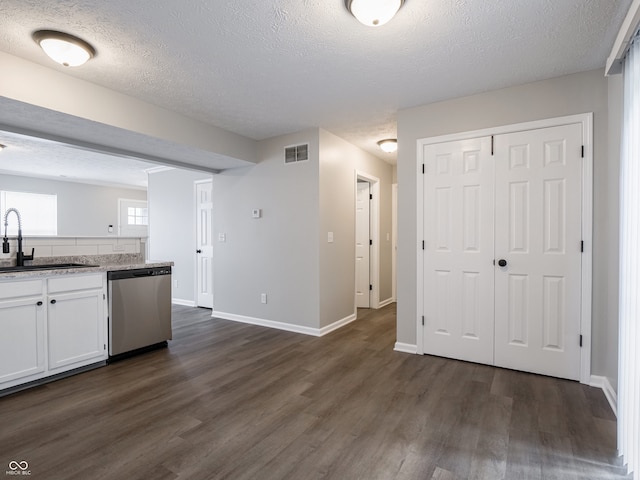 3734 Lacebark Dr, Indianapolis, IN 46235 - kitchen featuring stainless steel dishwasher, a sink, white cabinets, dark wood-style floors, and a textured ceiling