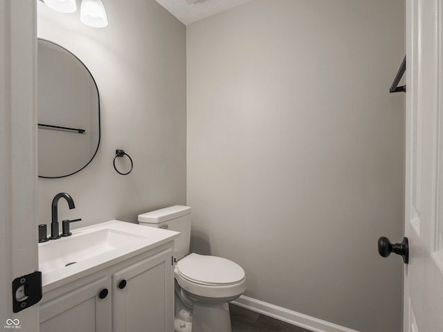 3734 Lacebark Dr, Indianapolis, IN 46235 - half bath with toilet, vanity, wood finished floors, and baseboards