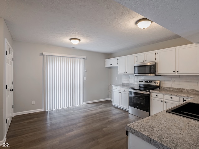 3734 Lacebark Dr, Indianapolis, IN 46235 - kitchen with stainless steel appliances, baseboards, white cabinetry, dark wood-style floors, and decorative backsplash
