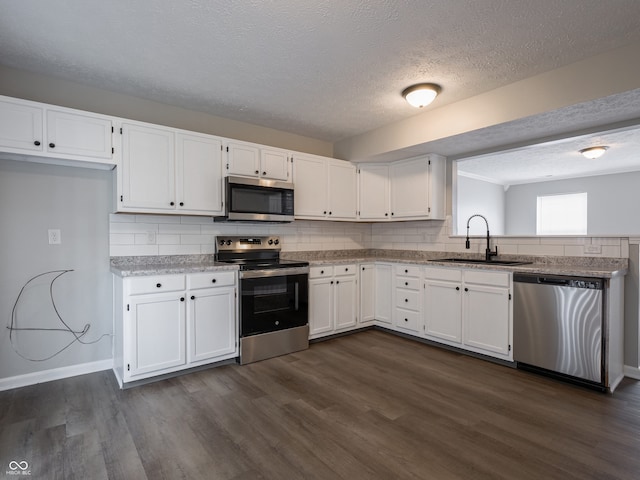 3734 Lacebark Dr, Indianapolis, IN 46235 - kitchen featuring stainless steel appliances, a sink, white cabinets, and a textured ceiling