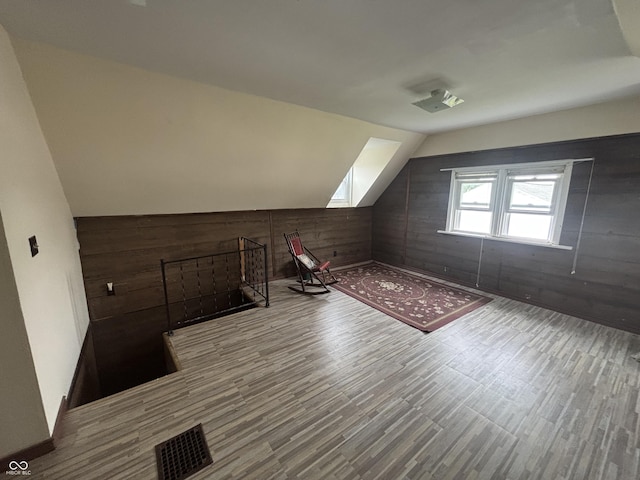 5553 N County Road 10 E, Greensburg, IN 47240 - additional living space with wooden walls, wood finished floors, lofted ceiling, and a skylight