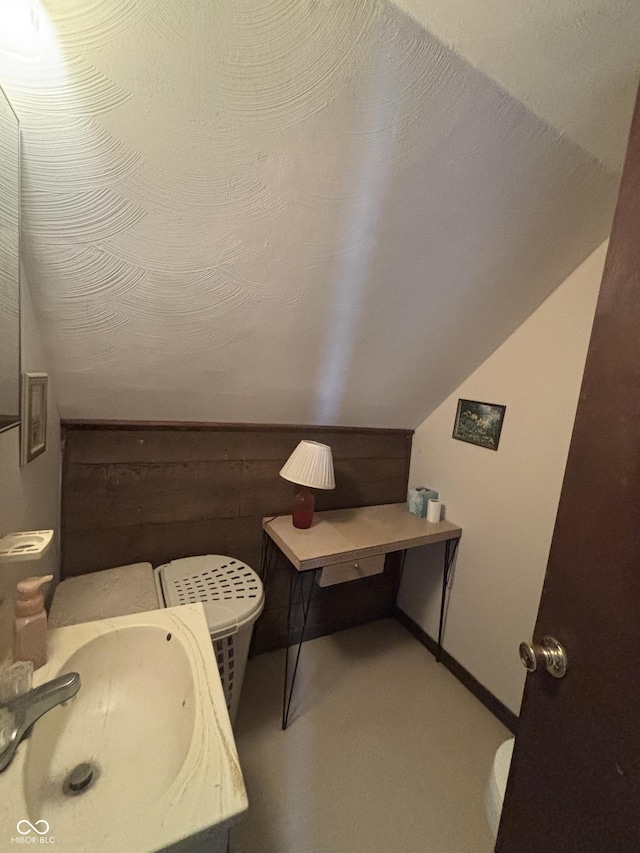 5553 N County Road 10 E, Greensburg, IN 47240 - bathroom with a sink, lofted ceiling, and baseboards