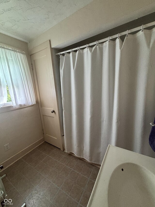 5553 N County Road 10 E, Greensburg, IN 47240 - full bath with a textured ceiling, tile patterned floors, and a sink