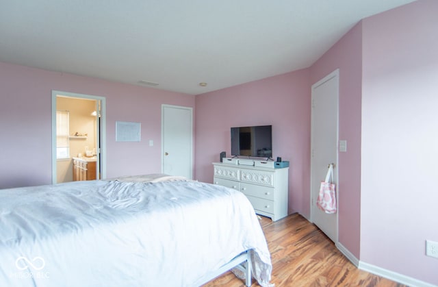 8056 Maple Stream Blvd, Indianapolis, IN 46217 - bedroom with light wood-style floors and connected bathroom