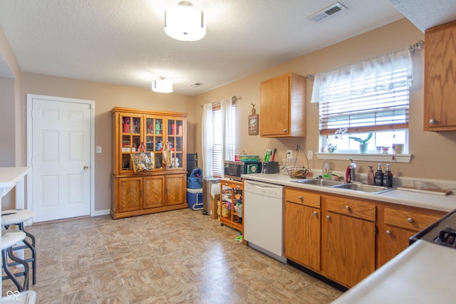 8056 Maple Stream Blvd, Indianapolis, IN 46217 - kitchen featuring dishwasher, a sink, plenty of natural light, light countertops, and a textured ceiling
