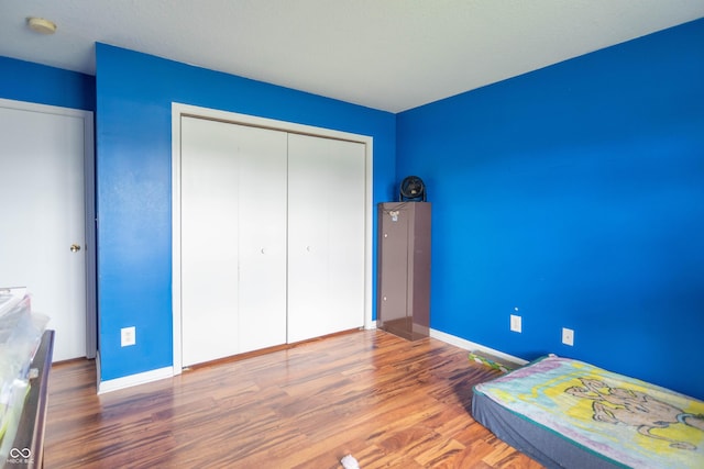8056 Maple Stream Blvd, Indianapolis, IN 46217 - unfurnished bedroom with wood finished floors, a closet, and baseboards