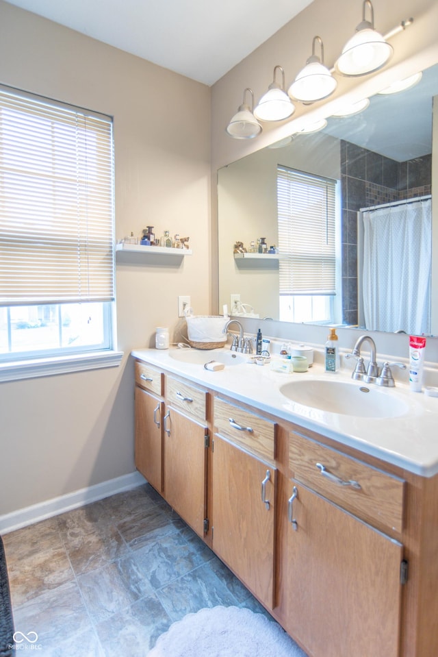 8056 Maple Stream Blvd, Indianapolis, IN 46217 - bathroom featuring double vanity, a shower with shower curtain, and baseboards