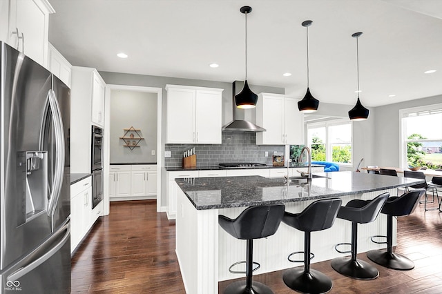 2789 W High Grove Cir, Zionsville, IN 46077 - kitchen with stainless steel appliances, wall chimney range hood, dark wood finished floors, decorative backsplash, and white cabinets