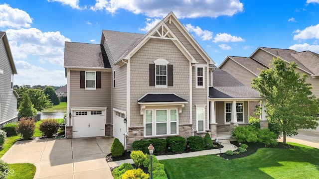2789 W High Grove Cir, Zionsville, IN 46077 - craftsman-style house featuring driveway, stone siding, a garage, a front yard, and roof with shingles