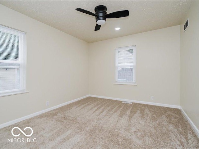 3558 N Gladstone Ave, Indianapolis, IN 46218 - empty room featuring carpet floors, baseboards, a ceiling fan, and a textured ceiling