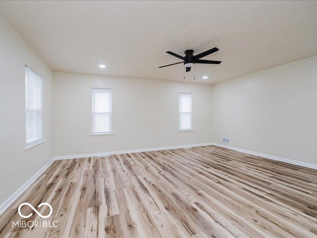 3558 N Gladstone Ave, Indianapolis, IN 46218 - spare room with wood finished floors, healthy amount of natural light, baseboards, a ceiling fan, and recessed lighting