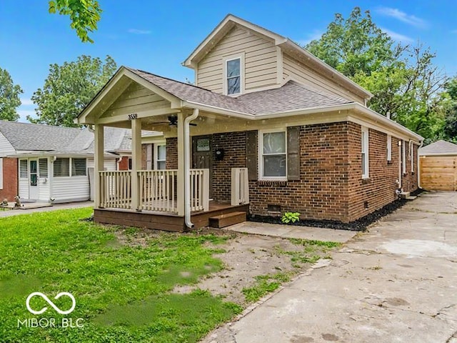 3558 N Gladstone Ave, Indianapolis, IN 46218 - view of front of home with covered porch, brick siding, roof with shingles, and crawl space