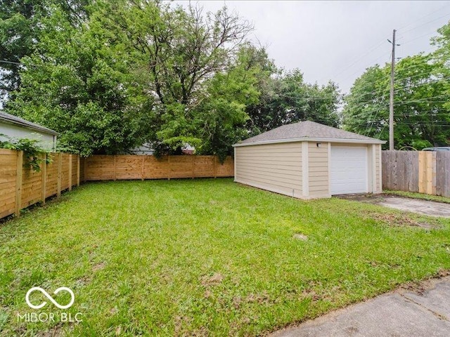 3558 N Gladstone Ave, Indianapolis, IN 46218 - view of yard featuring an outbuilding, driveway, and a detached garage