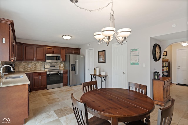 6927 Rose Tree Ct, Indianapolis, IN 46237 - dining room with arched walkways and a chandelier
