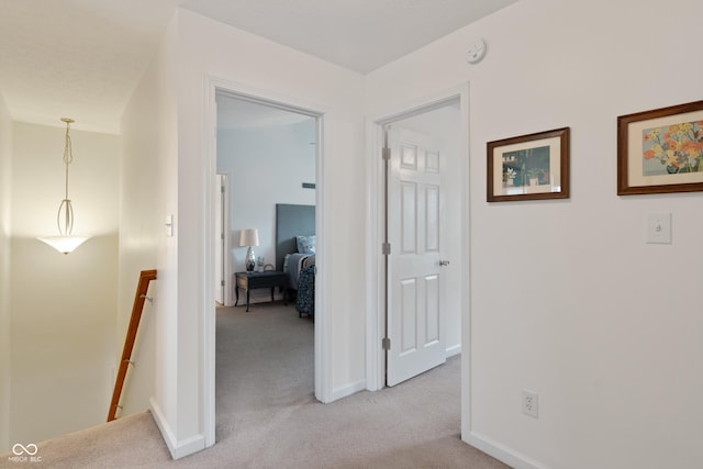 6927 Rose Tree Ct, Indianapolis, IN 46237 - hall with an upstairs landing, light colored carpet, and baseboards