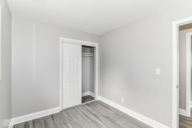 1820 Hemlock Ln, Plainfield, IN 46168 - unfurnished bedroom with light wood-style floors, baseboards, and a closet