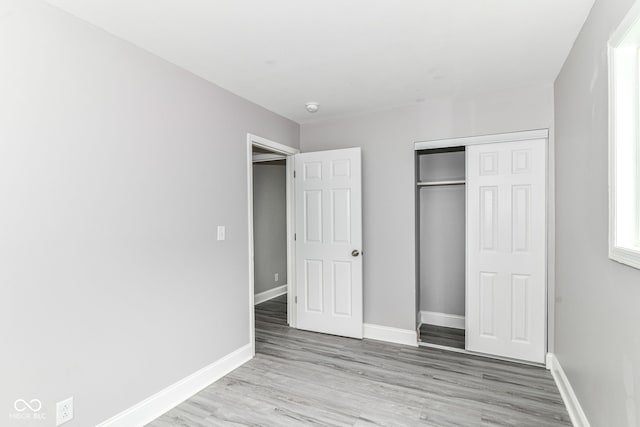 1820 Hemlock Ln, Plainfield, IN 46168 - unfurnished bedroom featuring wood finished floors, baseboards, and a closet