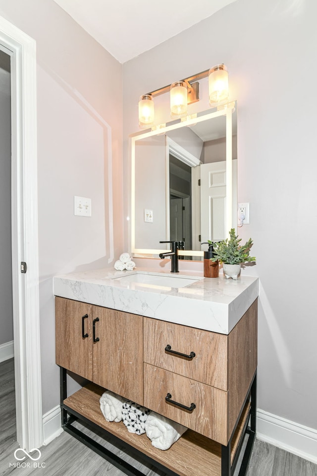 1820 Hemlock Ln, Plainfield, IN 46168 - bathroom with vanity, baseboards, and wood finished floors