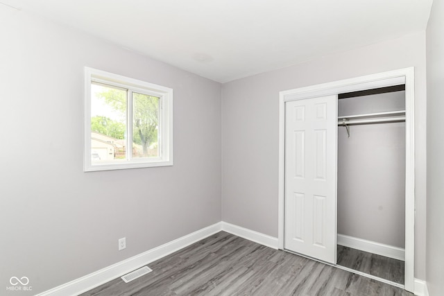 1820 Hemlock Ln, Plainfield, IN 46168 - unfurnished bedroom with wood finished floors, baseboards, and a closet