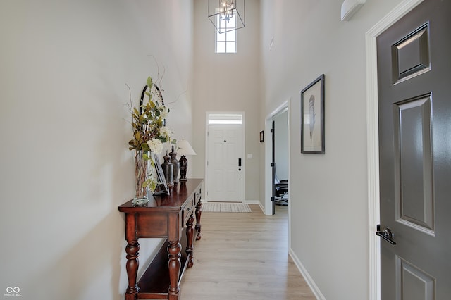 4163 Ironclad Dr, Bargersville, IN 46106 - entryway featuring a chandelier, light wood-type flooring, and a towering ceiling