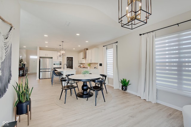 4163 Ironclad Dr, Bargersville, IN 46106 - dining area featuring a chandelier, light wood finished floors, recessed lighting, and lofted ceiling