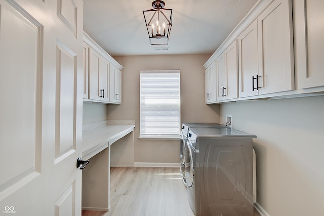4163 Ironclad Dr, Bargersville, IN 46106 - laundry room featuring washing machine and dryer, cabinet space, light wood-type flooring, a desk, and a chandelier