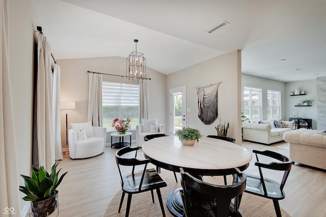 4163 Ironclad Dr, Bargersville, IN 46106 - dining area with light wood-style flooring, plenty of natural light, a chandelier, and lofted ceiling