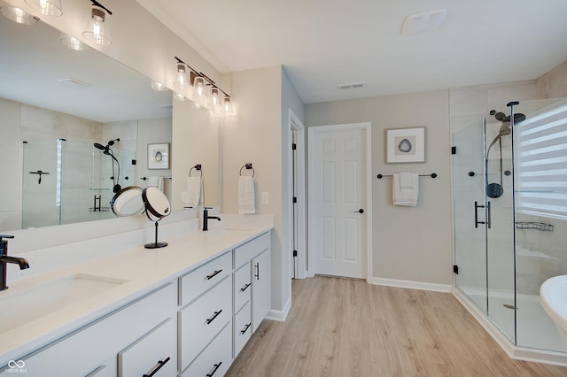 4163 Ironclad Dr, Bargersville, IN 46106 - bathroom featuring wood finished floors, a shower stall, and double vanity