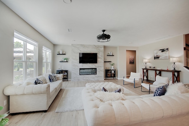 4163 Ironclad Dr, Bargersville, IN 46106 - living room featuring a premium fireplace and light wood-style flooring
