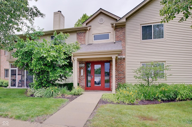 1074 Timber Creek Dr Unit 8, Carmel, IN 46032 - property entrance with a lawn, a chimney, and brick siding