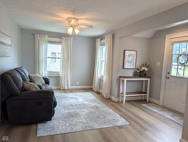 1637 Meridian St, Columbus, IN 47201 - living area with light wood finished floors, ceiling fan, and baseboards