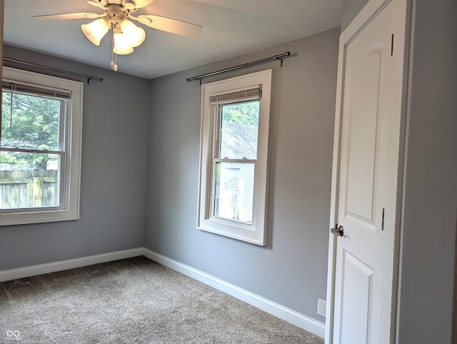 1637 Meridian St, Columbus, IN 47201 - carpeted spare room with baseboards and a ceiling fan