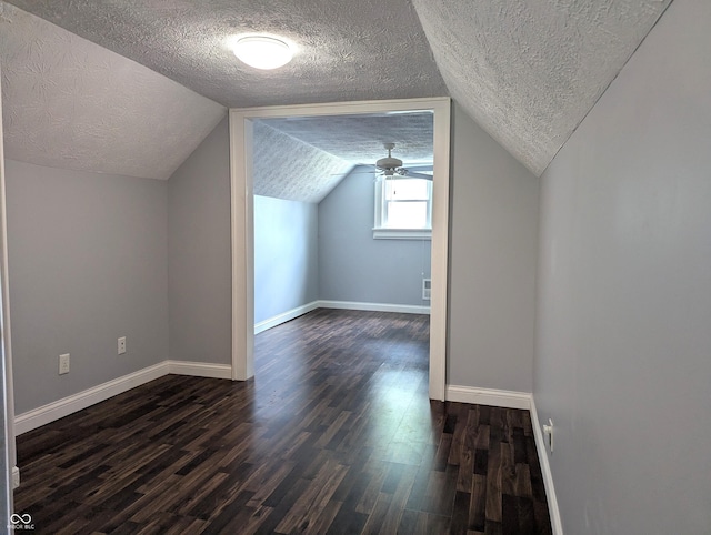 1637 Meridian St, Columbus, IN 47201 - bonus room featuring a textured ceiling, dark wood finished floors, baseboards, vaulted ceiling, and a ceiling fan