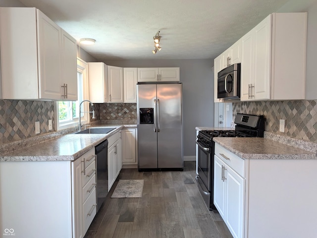 1637 Meridian St, Columbus, IN 47201 - kitchen featuring stainless steel appliances, a sink, dark wood-style floors, white cabinetry, and tasteful backsplash