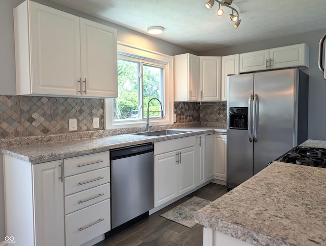 1637 Meridian St, Columbus, IN 47201 - kitchen with stainless steel appliances, a sink, tasteful backsplash, dark wood-style flooring, and white cabinetry