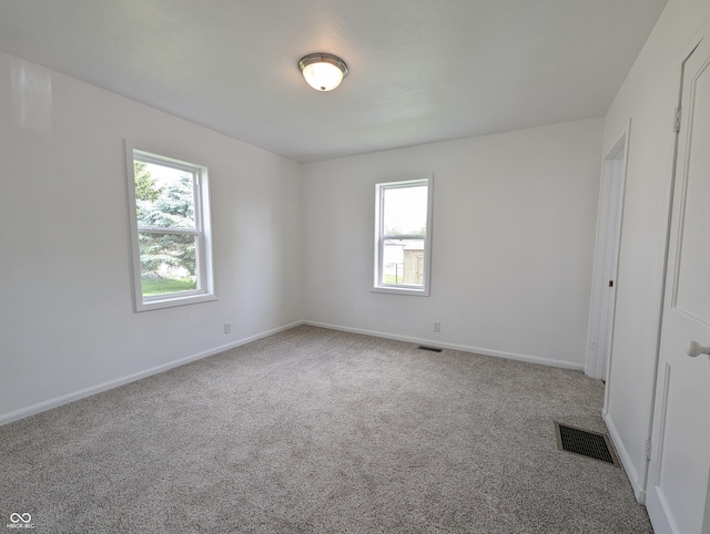 102 S W St, Milroy, IN 46156 - empty room with carpet flooring, healthy amount of natural light, and baseboards