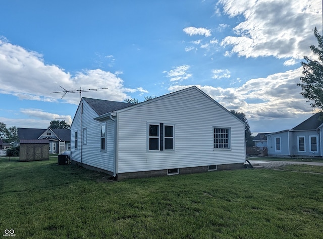 102 S W St, Milroy, IN 46156 - view of home's exterior featuring a yard and central AC