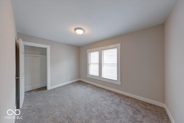 418 Eastern Ave, Indianapolis, IN 46201 - unfurnished bedroom with carpet flooring, a textured ceiling, and a closet
