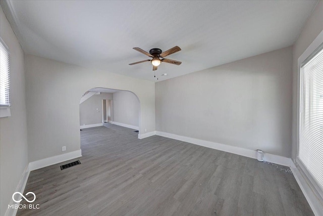 418 Eastern Ave, Indianapolis, IN 46201 - spare room featuring ceiling fan, arched walkways, and wood finished floors