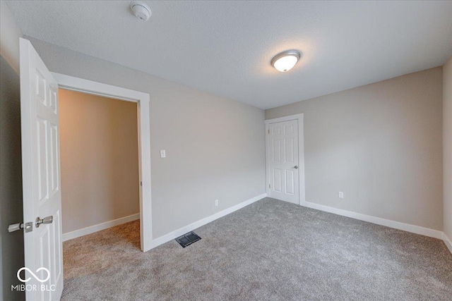 418 Eastern Ave, Indianapolis, IN 46201 - spare room with carpet flooring, a textured ceiling, and a smoke detector