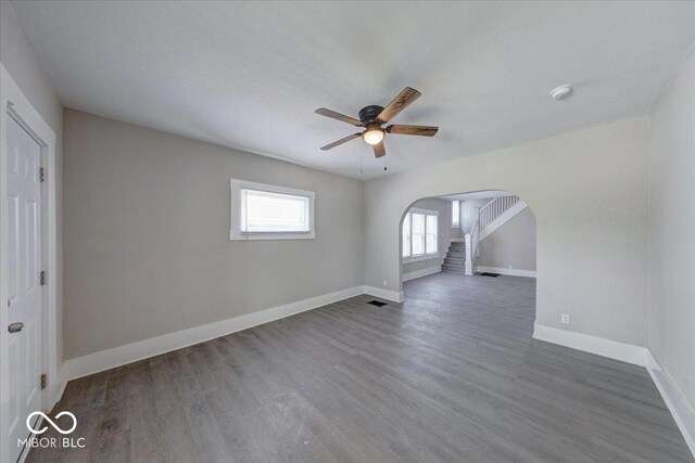 418 Eastern Ave, Indianapolis, IN 46201 - spare room with arched walkways, ceiling fan, wood finished floors, and a smoke detector