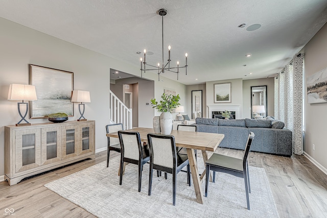 587 Bluestem Ln, New Whiteland, IN 46184 - dining space featuring wood finished floors, baseboards, a chandelier, stairway, and recessed lighting