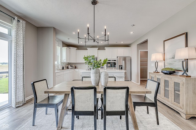 587 Bluestem Ln, New Whiteland, IN 46184 - dining area featuring plenty of natural light, light wood finished floors, a chandelier, baseboards, and recessed lighting