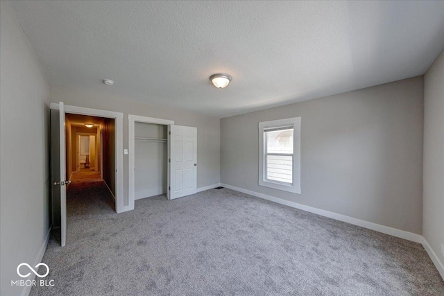 420 Eastern Ave, Indianapolis, IN 46201 - unfurnished bedroom featuring carpet flooring, a closet, and a textured ceiling