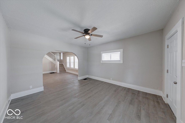 420 Eastern Ave, Indianapolis, IN 46201 - unfurnished room featuring arched walkways, a ceiling fan, a textured ceiling, and wood finished floors