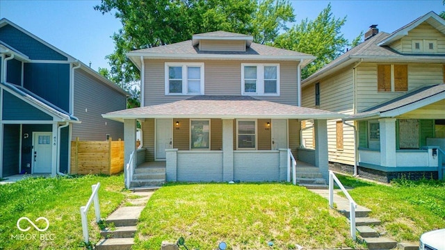 420 Eastern Ave, Indianapolis, IN 46201 - american foursquare style home featuring a porch, a front yard, and roof with shingles