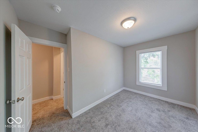 420 Eastern Ave, Indianapolis, IN 46201 - empty room featuring carpet, a smoke detector, and a textured ceiling